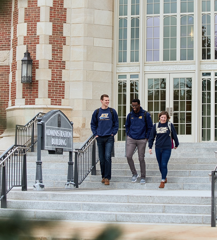 Group of Students Walking Outside of JCU's Administration Building