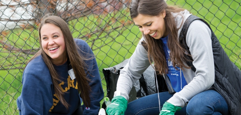 two women students smiling outside